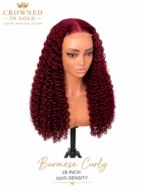 A mannequin head wearing a long, deep burgundy curly wig 'Burmese Curly 28 INCH 250% DENSITY'.