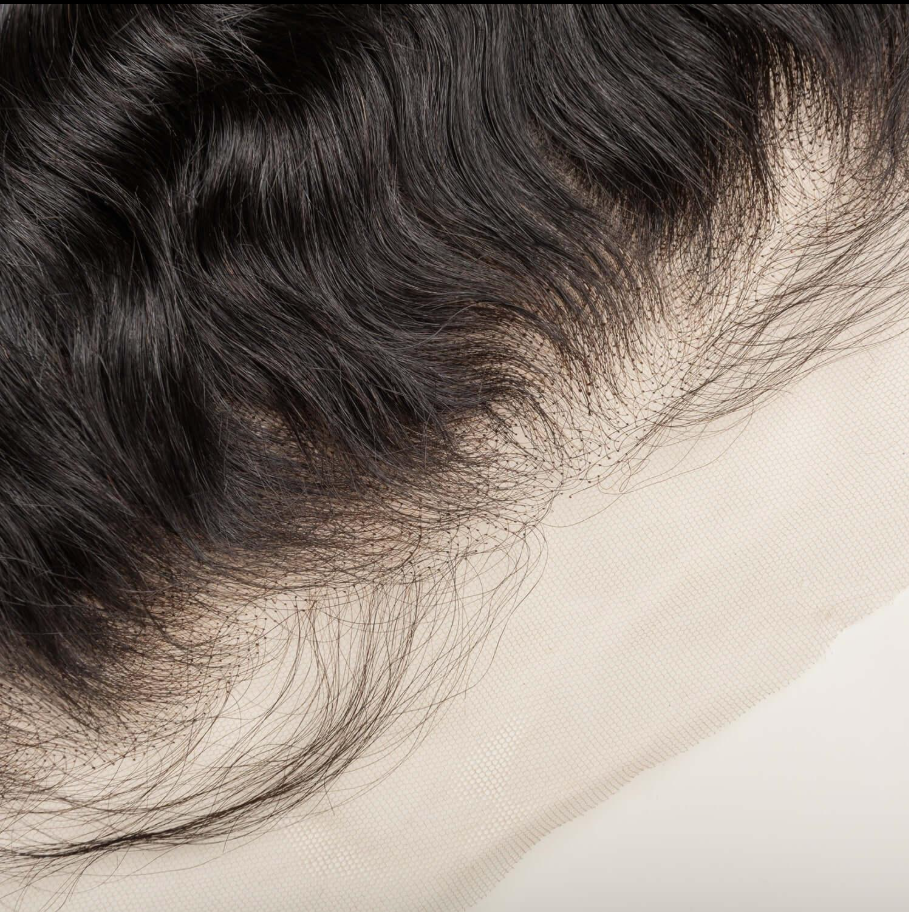 Detailed close-up of the realistic HD lace hairline on a natural black straight human hair wig